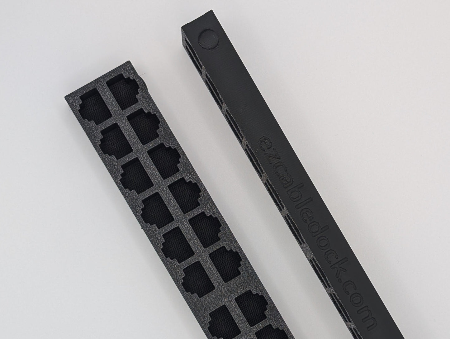 An image displaying two 24-port EZ Cable Docks: one showing the front view with RJ45 ports, and the other positioned on its side to highlight the raised circular indicator on the first port. This indicator aids in easy cable organization and port identification