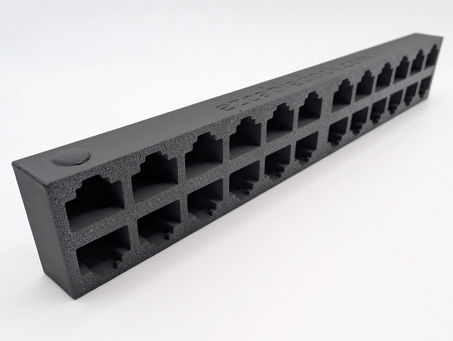 An image of a 24-port EZ Cable Dock highlighting the raised circular indicator on the first RJ45 port. This design feature helps users quickly identify the starting position for organizing Ethernet cables.