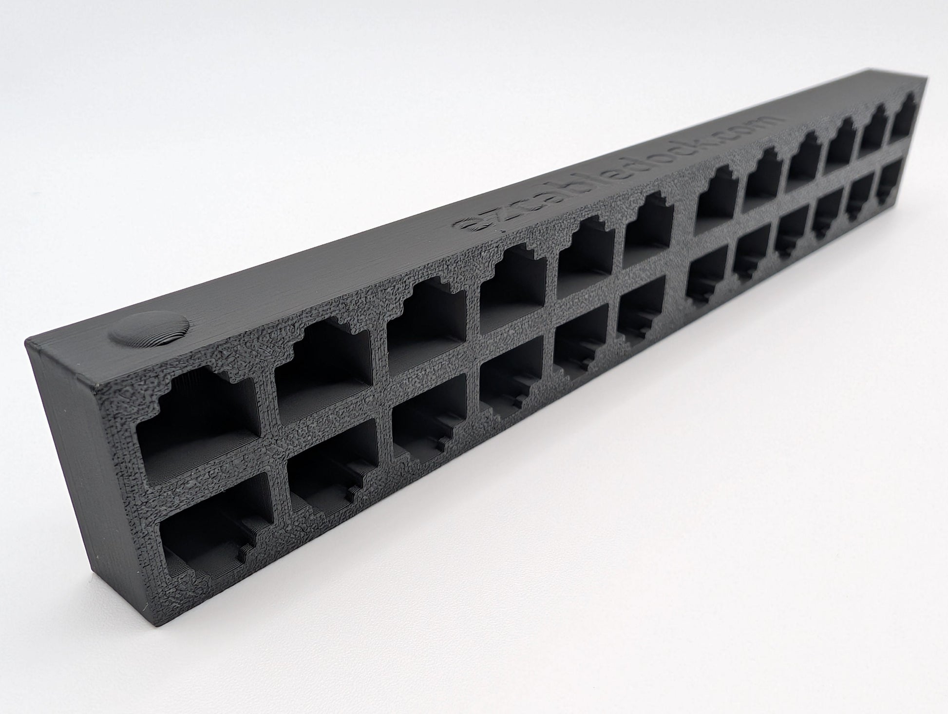 An image of a 24-port EZ Cable Dock highlighting the raised circular indicator on the first RJ45 port. This design feature helps users quickly identify the starting position for organizing Ethernet cables.