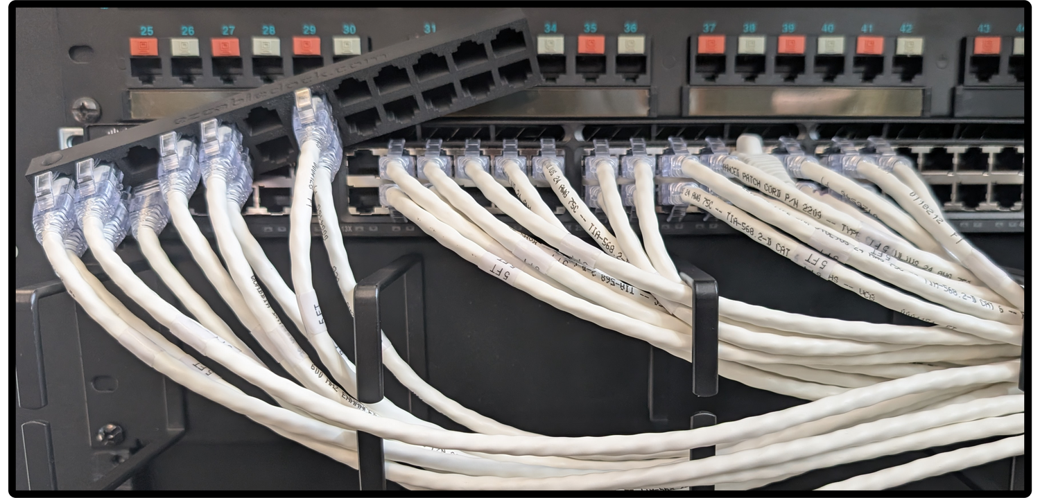 An image showing a network switch with Ethernet cables plugged in, alongside the EZ Cable Dock. Some cables are being transferred from the switch to the EZ Cable Dock, demonstrating how the dock temporarily holds and organizes the cables while maintaining their arrangement for easy reconnection.